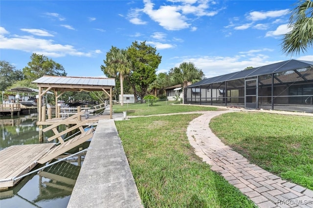 view of dock with a lanai, a yard, and a water view