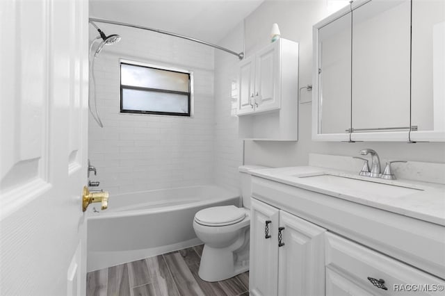 full bathroom with hardwood / wood-style floors, vanity, toilet, and tiled shower / bath combo