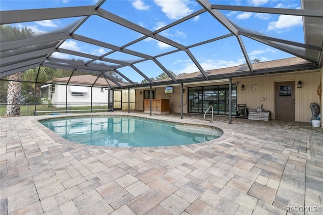 view of swimming pool with a lanai and a patio