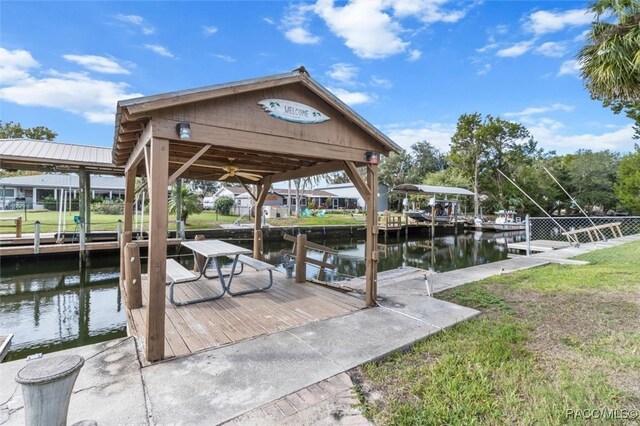 dock area featuring a yard and a water view