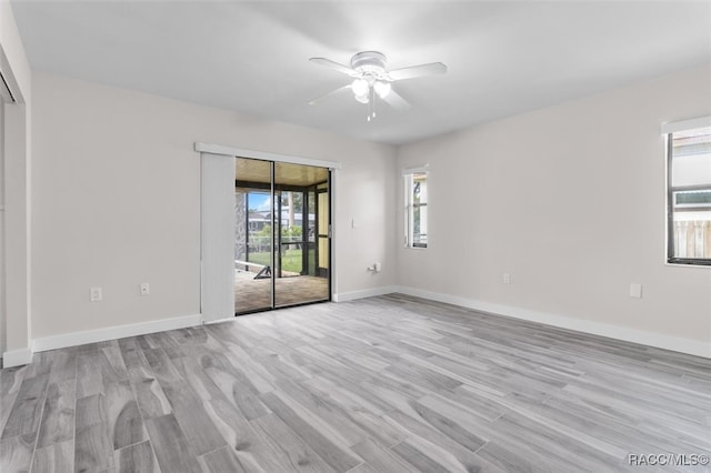 spare room with ceiling fan, plenty of natural light, and light hardwood / wood-style flooring