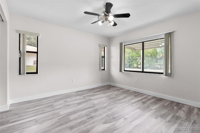 unfurnished room with a wealth of natural light, ceiling fan, and light hardwood / wood-style floors