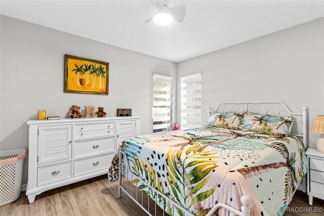 bedroom with light wood-style floors and a ceiling fan