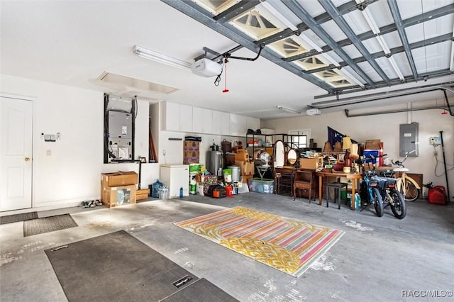 garage with a garage door opener, electric panel, heating unit, and a workshop area