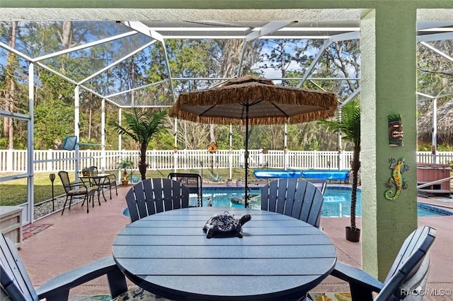 view of patio featuring outdoor dining area, a fenced backyard, a fenced in pool, and a lanai