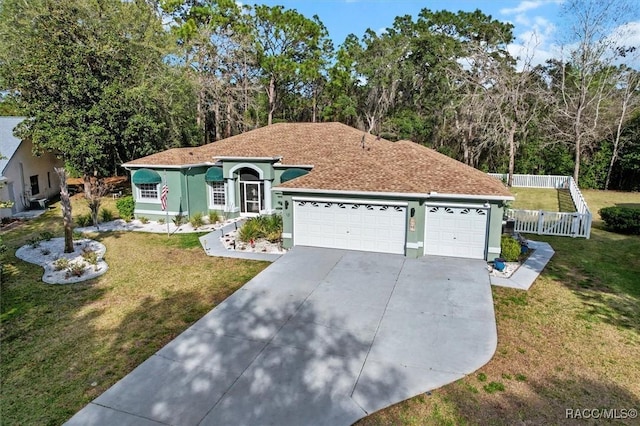 view of front of house with stucco siding, concrete driveway, fence, a garage, and a front lawn