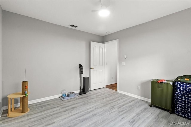 interior space featuring visible vents, baseboards, and wood finished floors