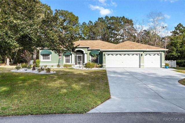 single story home featuring a garage, concrete driveway, stucco siding, fence, and a front yard