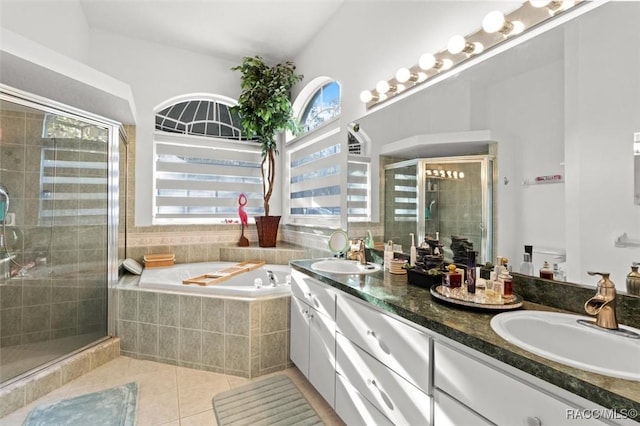 full bath with a bath, a shower stall, a sink, and tile patterned floors