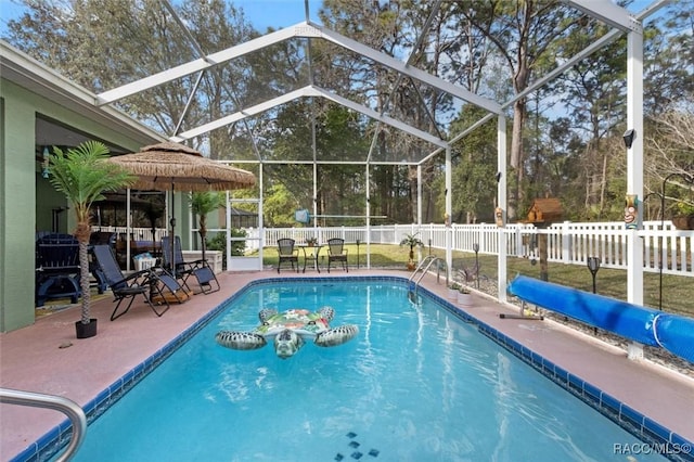 view of pool with a fenced in pool, a patio area, glass enclosure, and a fenced backyard