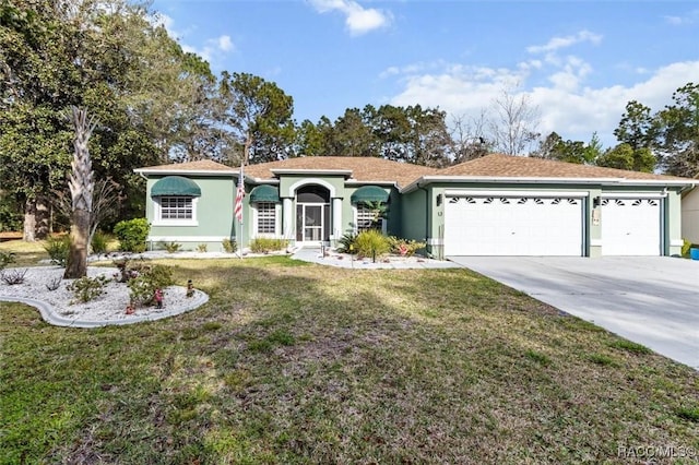 view of front of property featuring a garage, driveway, a front lawn, and stucco siding