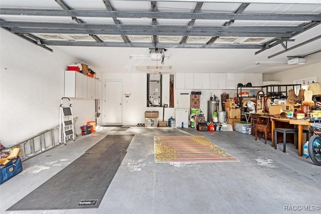 garage featuring a garage door opener and a workshop area