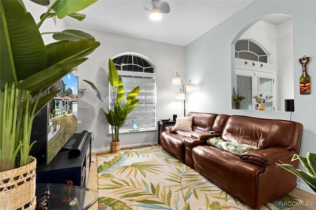 living area featuring arched walkways and baseboards