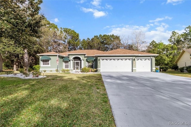 view of front of property with a garage, a front yard, driveway, and stucco siding