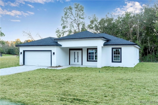 view of front of house featuring a front yard and a garage