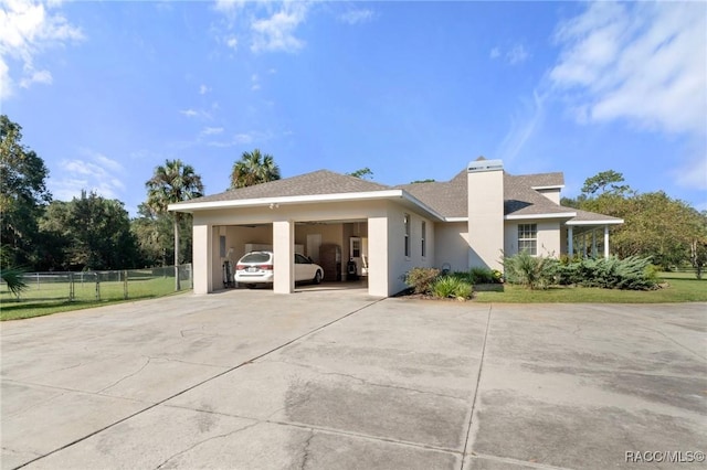 view of home's exterior featuring a carport and a yard