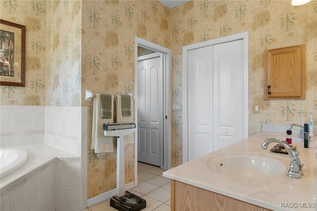 bathroom featuring tile patterned floors, vanity, and a relaxing tiled tub