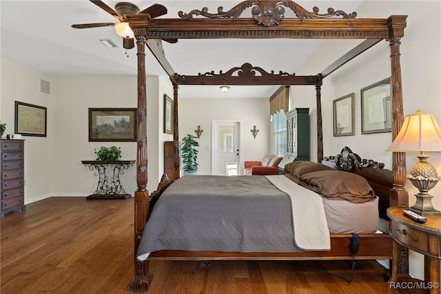 bedroom with ceiling fan and dark wood-type flooring