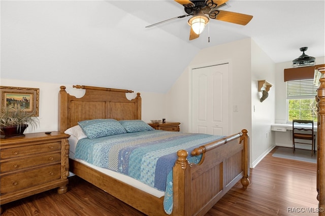 bedroom with ceiling fan, dark hardwood / wood-style flooring, lofted ceiling, and a closet