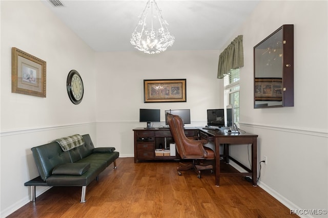 office area with hardwood / wood-style floors and an inviting chandelier