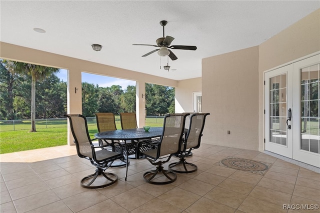 sunroom / solarium featuring french doors and ceiling fan