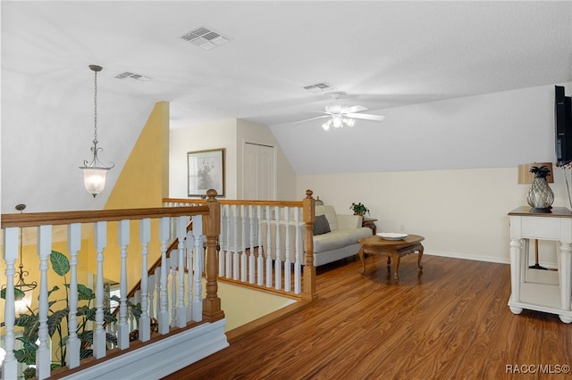 interior space featuring hardwood / wood-style floors, ceiling fan, and vaulted ceiling