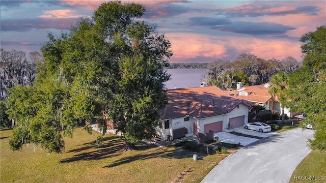 aerial view at dusk with a water view