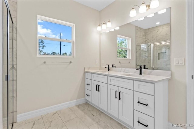 full bathroom with marble finish floor, double vanity, a stall shower, a sink, and baseboards