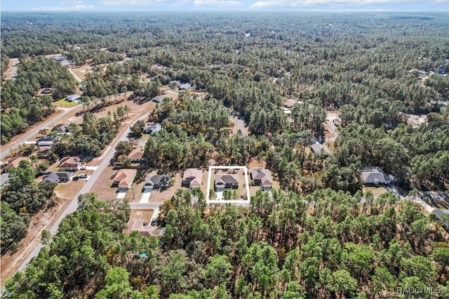 drone / aerial view featuring a forest view