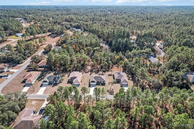 birds eye view of property featuring a residential view and a view of trees