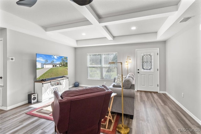 living room featuring beamed ceiling, wood-type flooring, and coffered ceiling