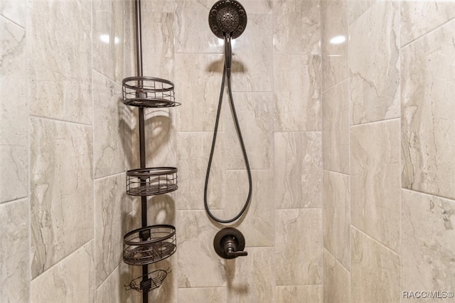 interior details featuring a tile shower