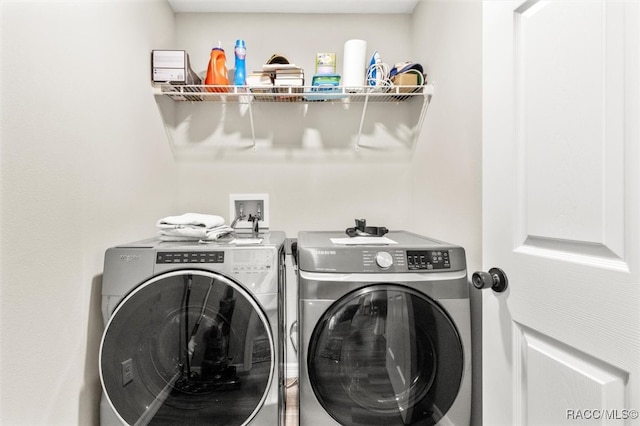 clothes washing area with independent washer and dryer