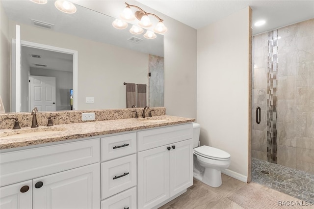 bathroom featuring vanity, toilet, and a shower with door