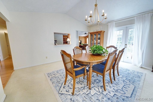 carpeted dining room featuring a chandelier, french doors, vaulted ceiling, and baseboards