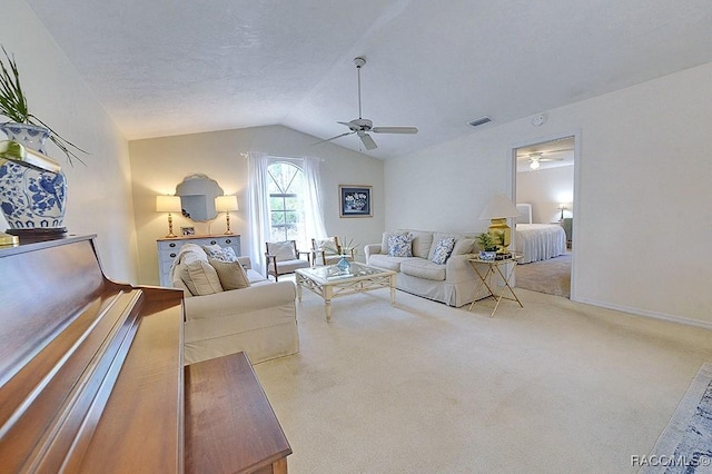 living room with visible vents, ceiling fan, carpet, vaulted ceiling, and a textured ceiling