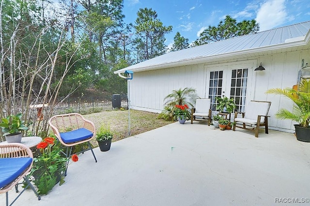 view of patio featuring french doors and fence