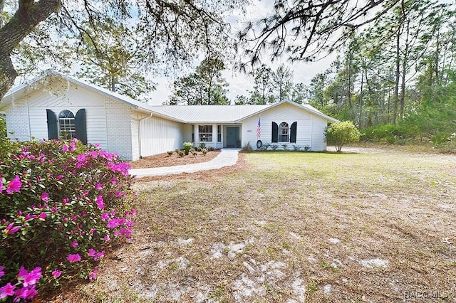 ranch-style home with a front lawn and brick siding