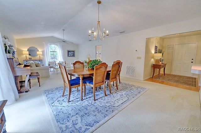 dining room with light carpet, ceiling fan with notable chandelier, lofted ceiling, and visible vents