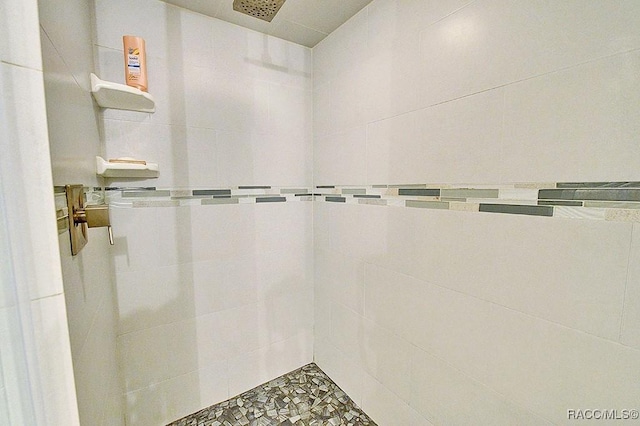 full bathroom with tiled shower