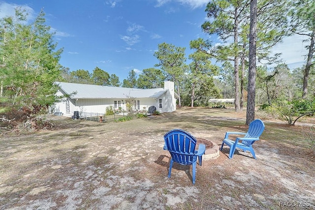 view of yard with an outdoor fire pit