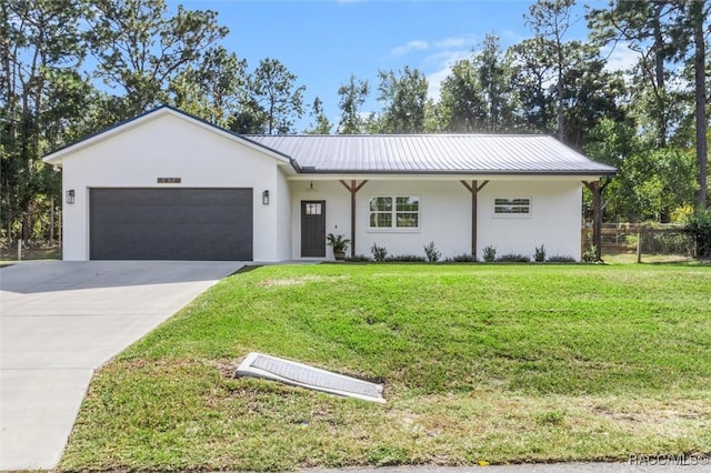 ranch-style home with a garage, a front lawn, and stucco siding