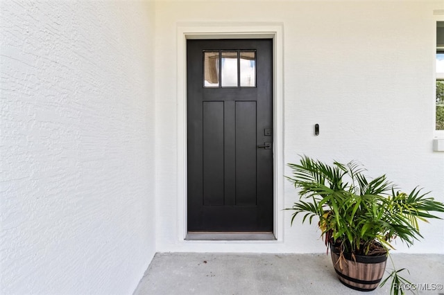 view of exterior entry with stucco siding