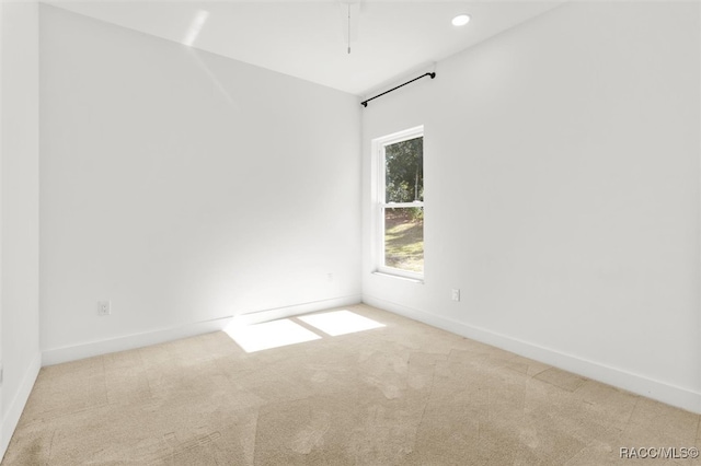 carpeted spare room with recessed lighting and baseboards