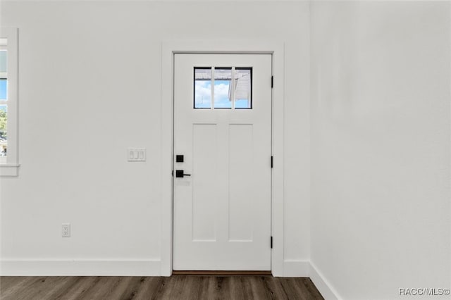 entrance foyer featuring plenty of natural light, dark wood finished floors, and baseboards