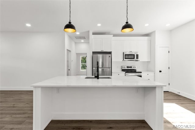 kitchen featuring white cabinetry, a large island, pendant lighting, and stainless steel appliances