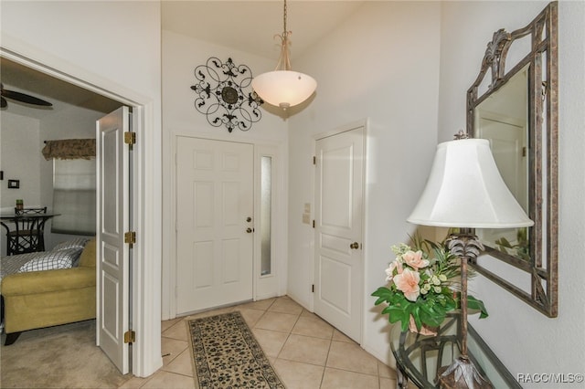 tiled entryway featuring high vaulted ceiling