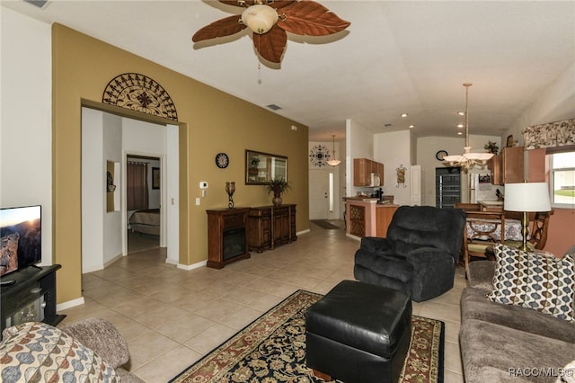 tiled living room featuring ceiling fan and lofted ceiling