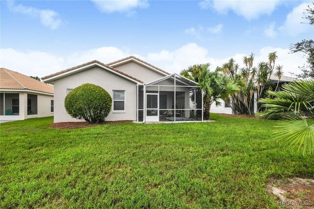 916 W Skyview Crossing Dr, Hernando, FL 34442 - rear view of property with stucco siding, a lawn, a tile roof, and a lanai
