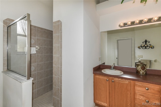 bathroom featuring vanity and a tile shower